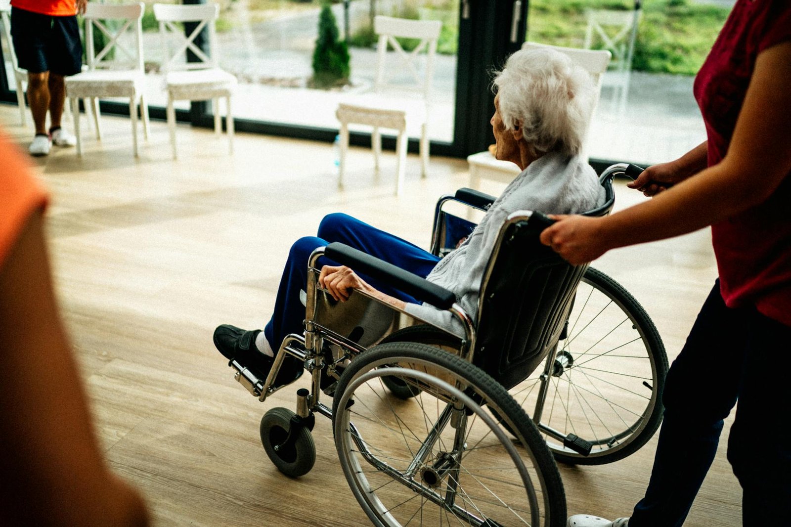 senior sitting in a wheelchair in a nursing home