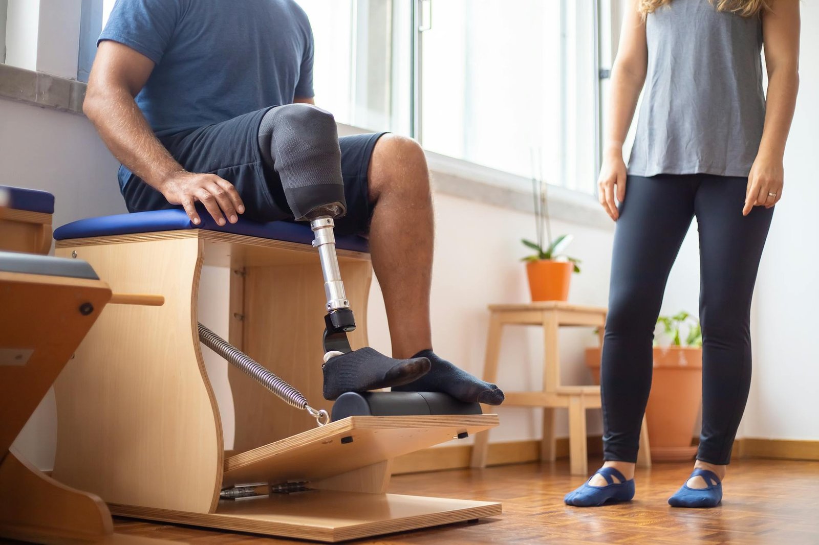 a sitting man rehabilitating with a prosthetic leg